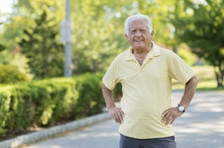 Fit male senior standing in driveway